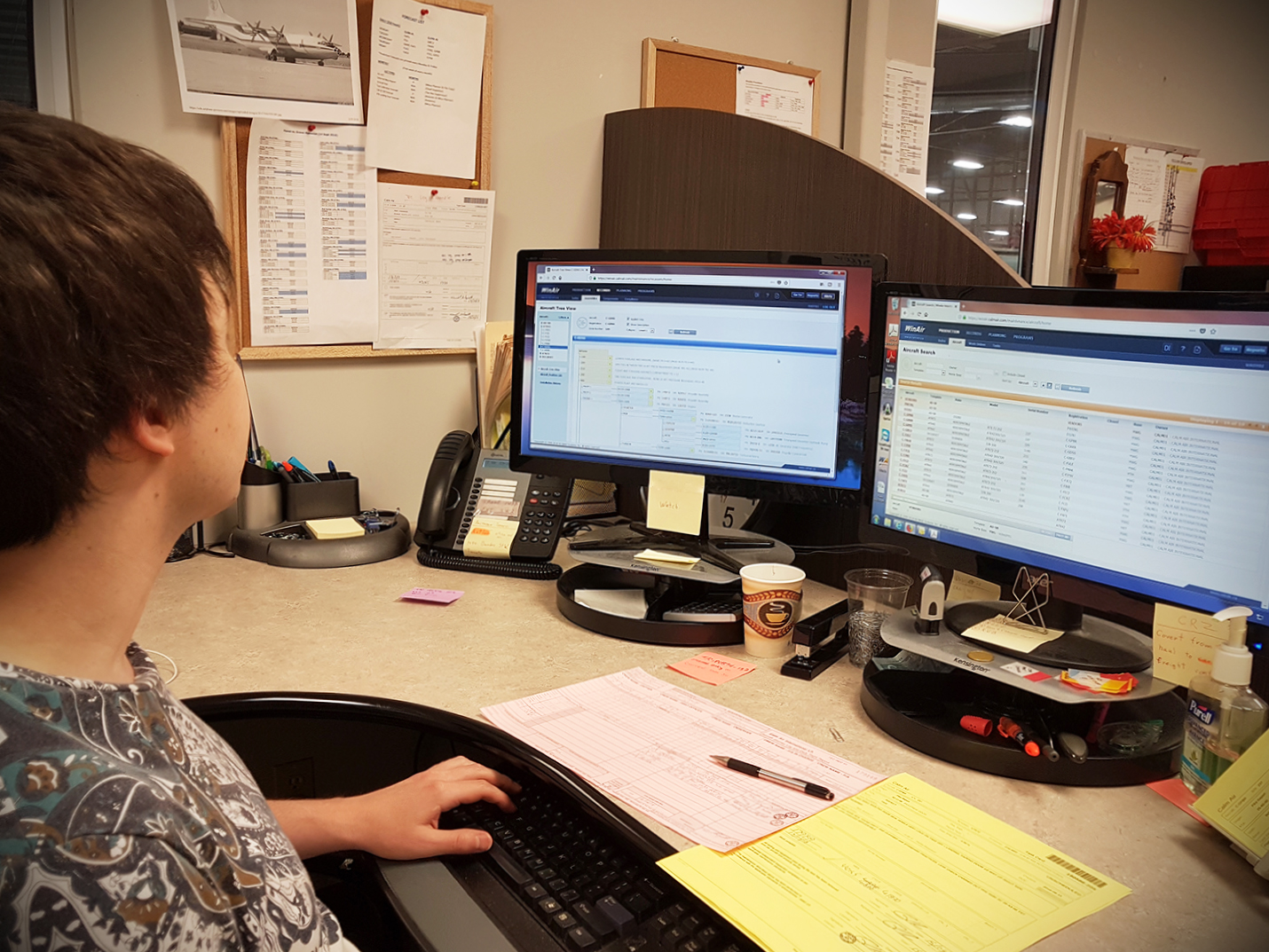 Calm Air Technical Records Clerk using WinAir at workstation