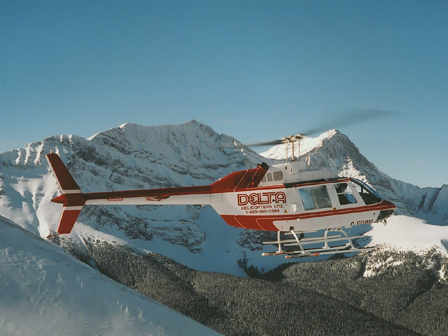 A Bell 206B helicopter operated by Delta Helicopters flies over the Rocky Mountains in Alberta, Canada © Delta Helicopters