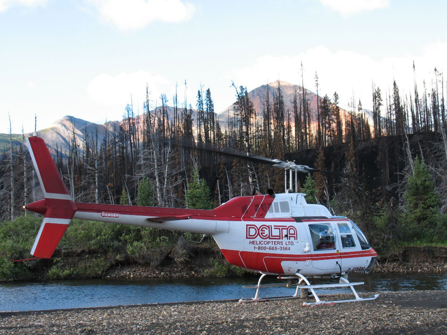 Delta Helicopters Bell 206B helicopter prepares for liftoff from a remote location in Alberta, Canada