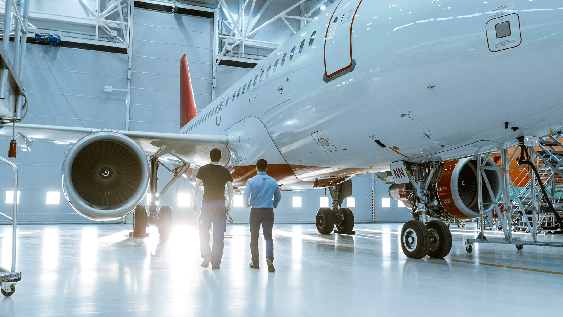 Aircraft mechanics and aircraft in hangar