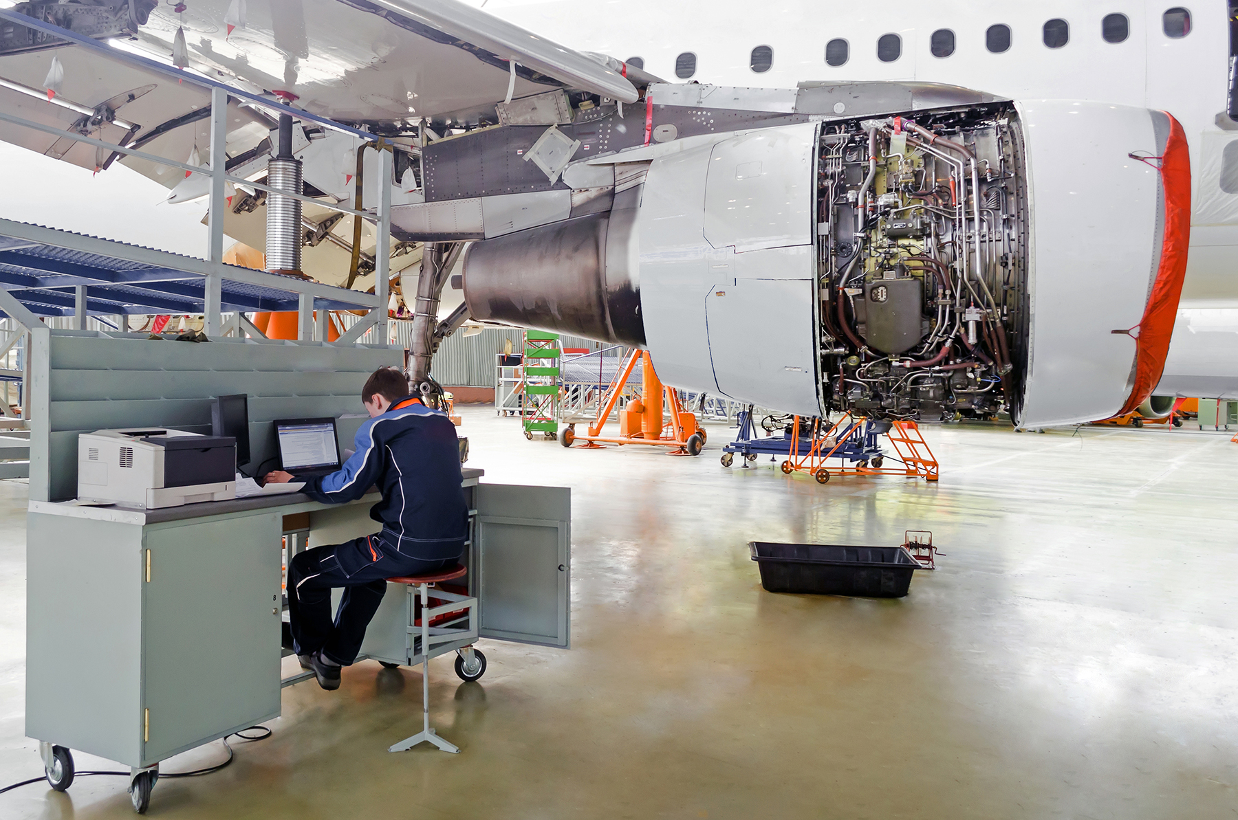 Aircraft Maintenance Technician at a Workstation in a Maintenance Hangar