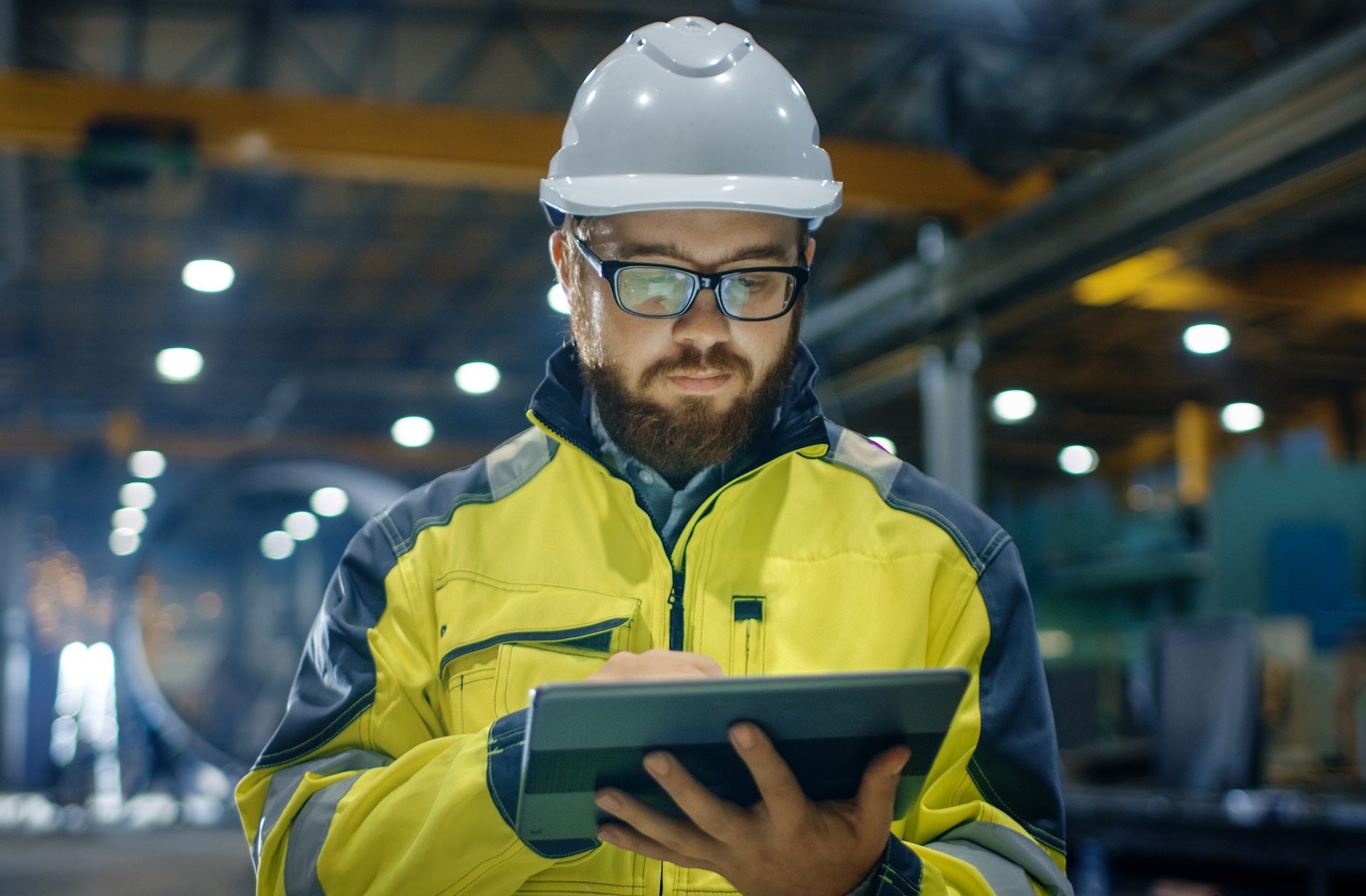 Aircraft Maintenance Engineer Viewing a Tablet in an Aircraft Hangar