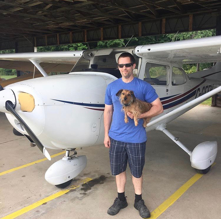 WinAir Senior Software Developer, Devon Ferns, with his dog, Ruby, and a Cessna 172 aircraft