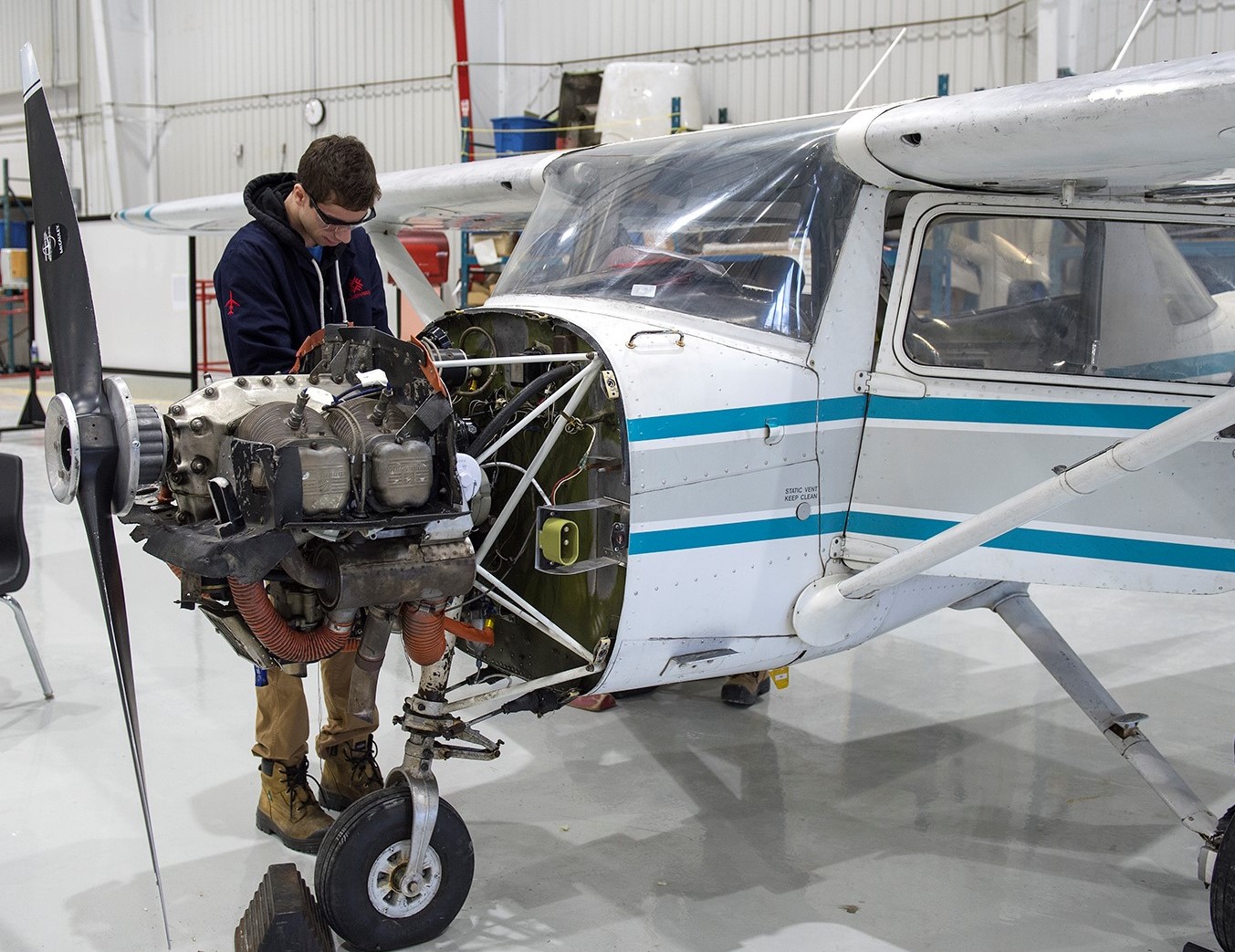 A student and instructor review documents at the maintenance hangar