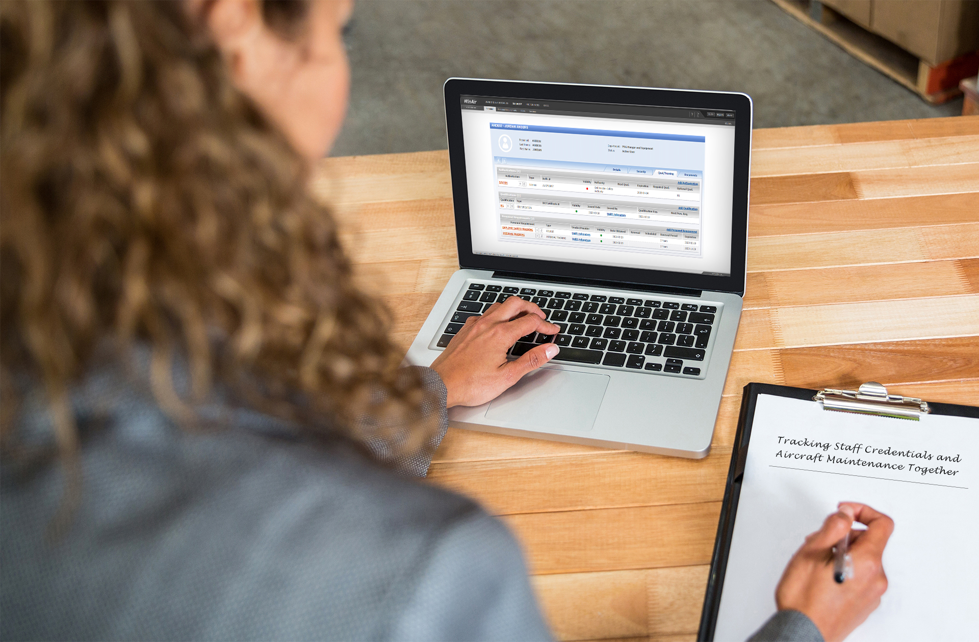 An employee accesses WinAir’s Qualification and Training enhancement from a laptop computer