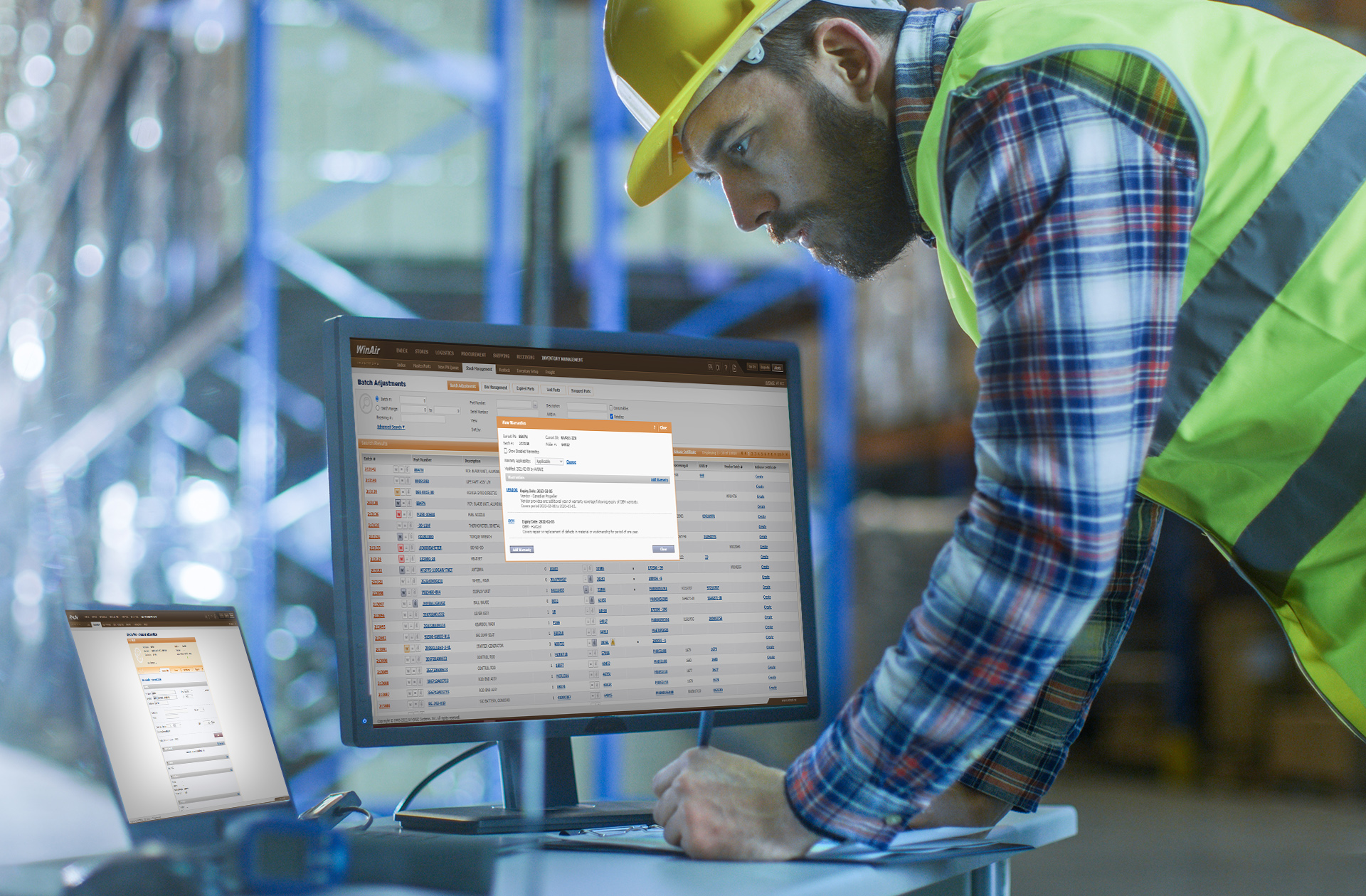 WinAir Master Parts Search screen displayed on laptop and Inventory Management Batch Adjustments screen with Warranties dialogue displayed on desktop