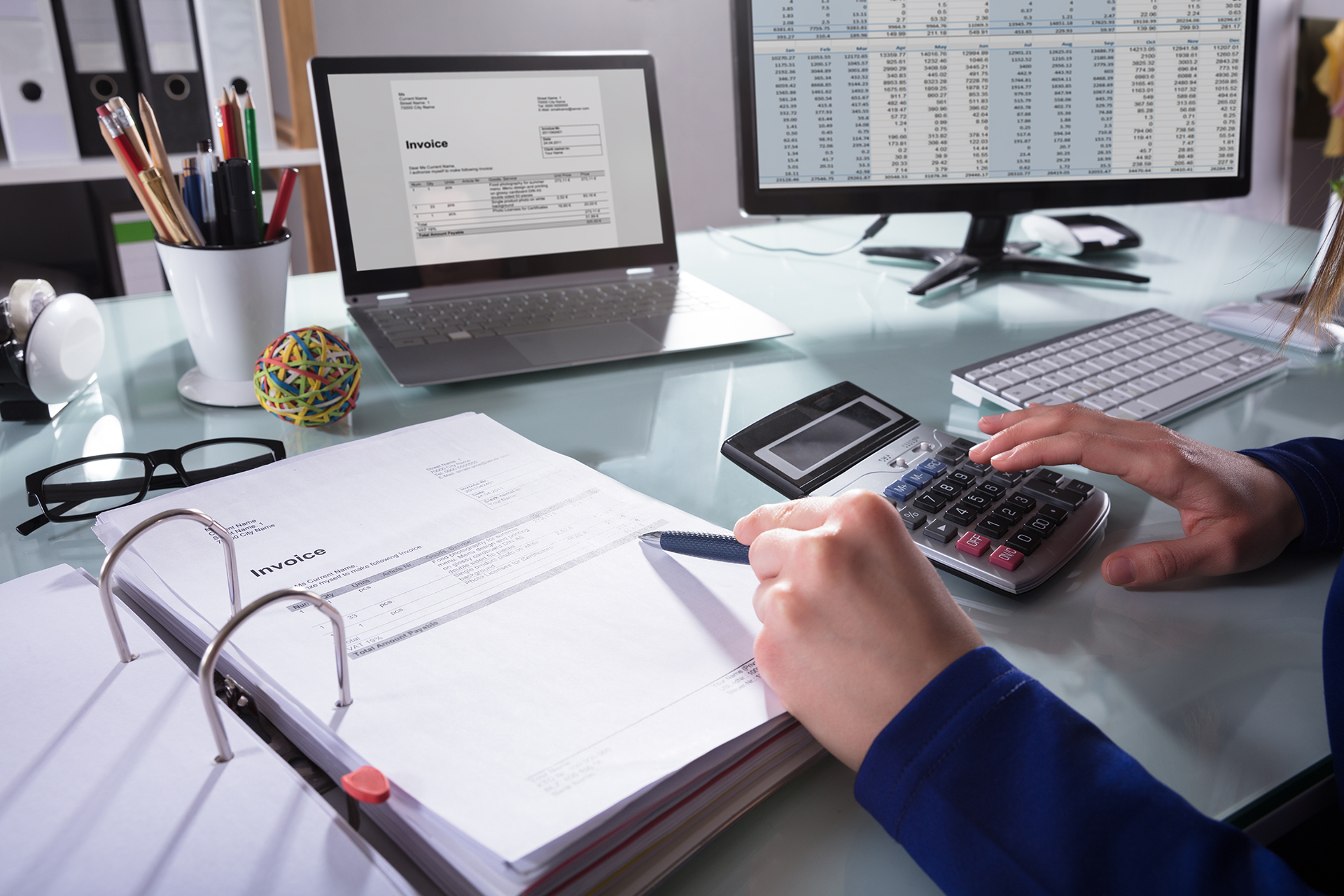 A staff member meticulously scans a spreadsheet in an attempt to identify the source of an error